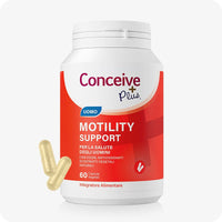 Conceive Plus Motility Support (IT) supplement bottle with bold red and white label, showing “Uomo” tag and 60 vegetable capsules for male fertility; two capsules displayed beside the container on a white background for clarity and accessibility.