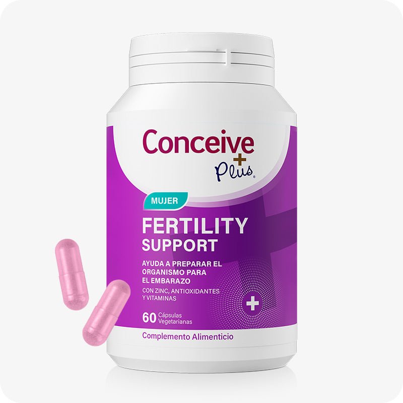Conceive Plus Women's Fertility Support (ES) supplement bottle for female reproductive health with 60 vegetarian capsules, shown with two loose pink capsules beside a white and purple container labeled in Spanish, placed on a clean white background.